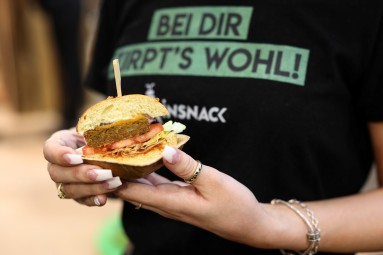 Woman holding burger, close-up burger 