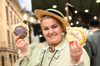 A woman holding a cheese.