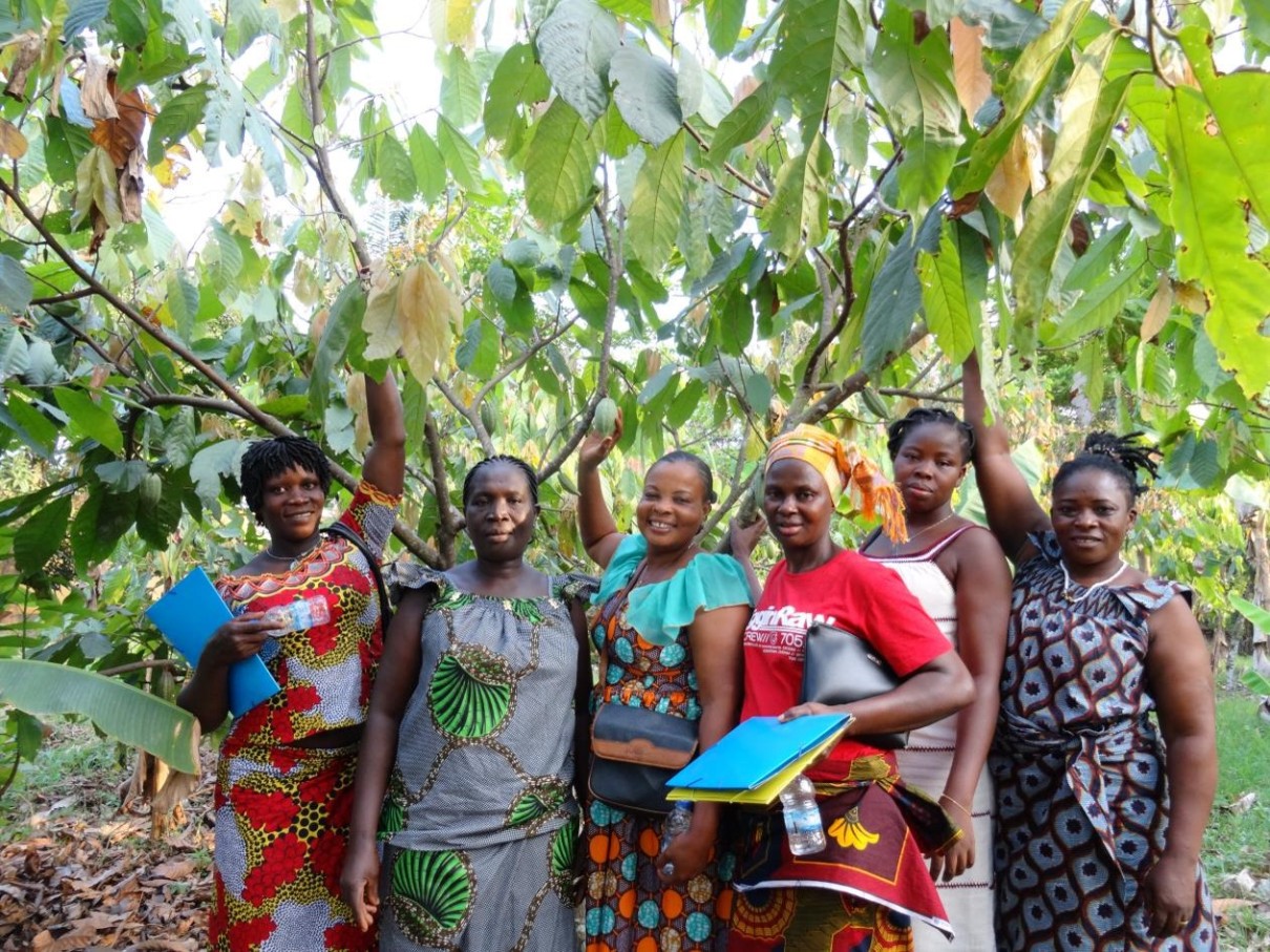 Women in front of a cocoa plant