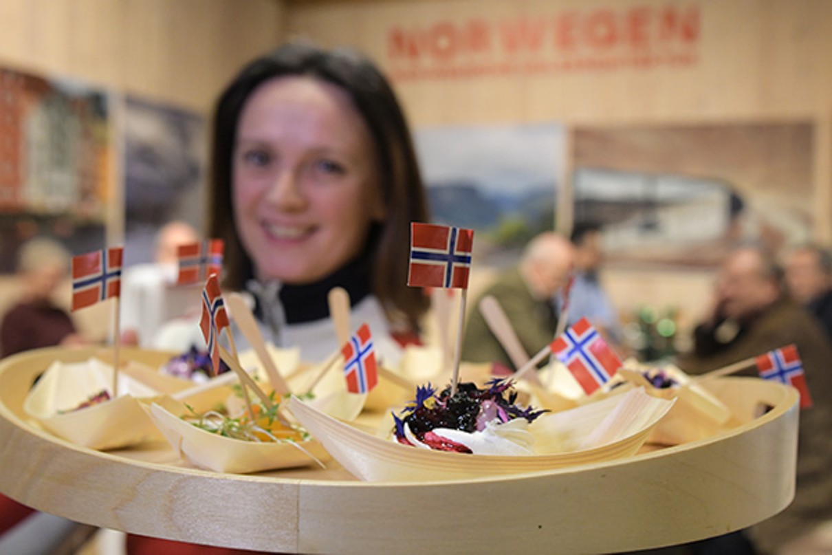 A woman with tidbits at the Norwegian stand.