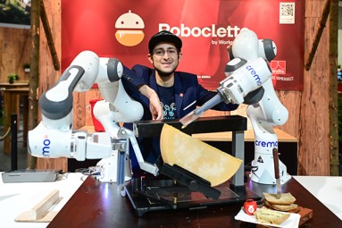 Man with a raclette robot