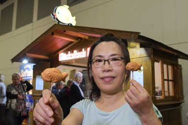 A woman with baked lucky fish.