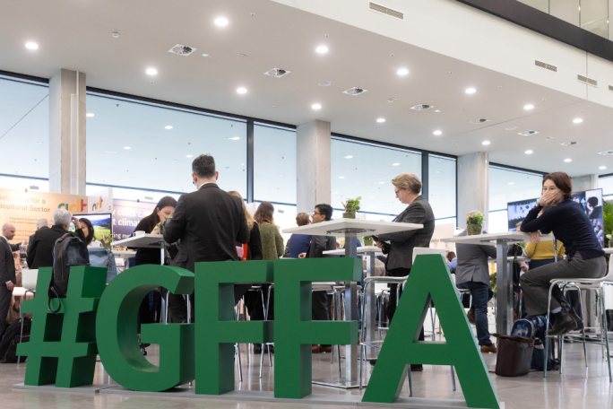 In the foreground you can see a display with the letters GFFA - in the background you can see trade fair guests.